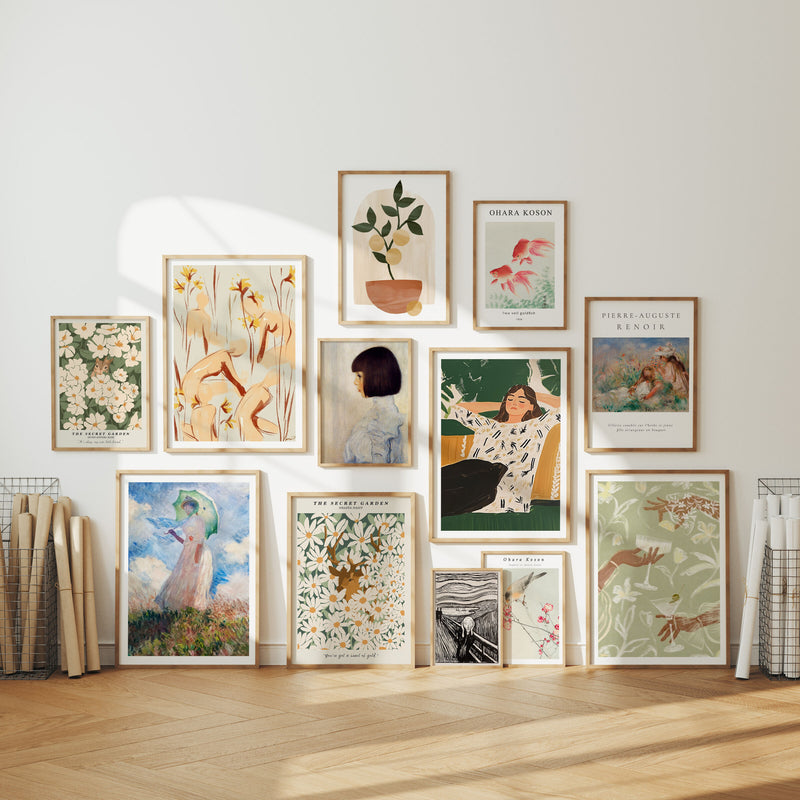 Collection of framed artworks on a wall with a neutral background