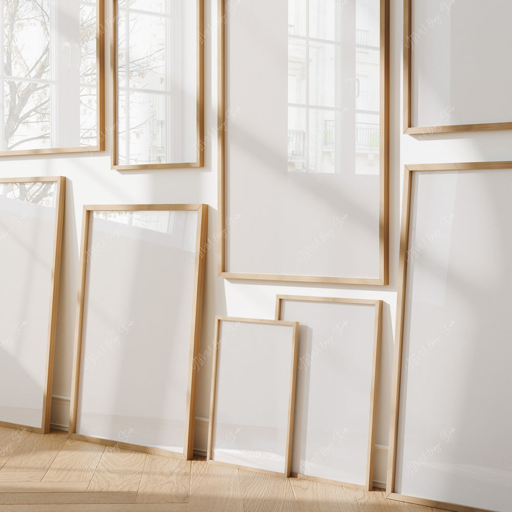 Set of wooden picture frames on a white wall