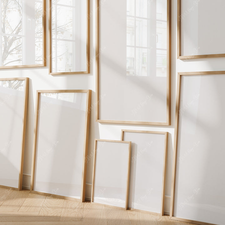 Set of wooden picture frames on a white wall
