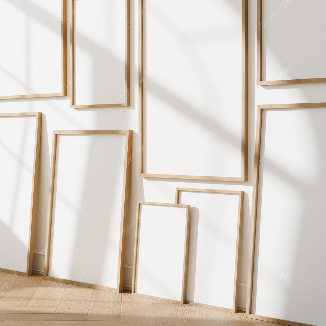 Set of wooden picture frames of different sizes on a white wall.